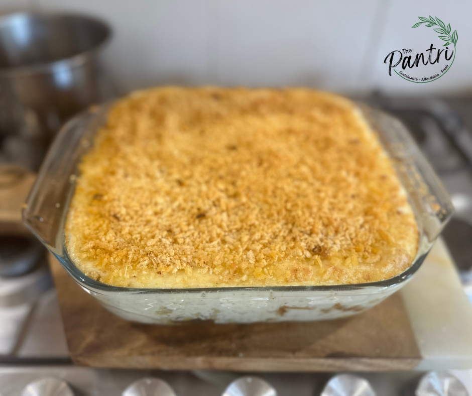 Ultimate Mac and cheese in a glass dish after being baked in the oven, with a bubbling panko crust